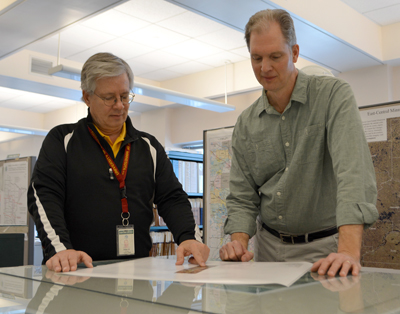 2 men looking at a map product