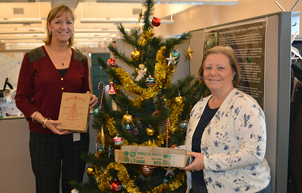 Photo of Cheryl Hunstock and Linda Bergen by Christmas tree.