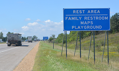 Rest area sign along busy highway