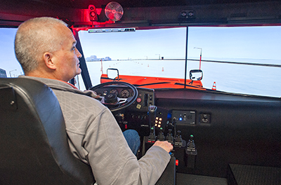 Photo of Andrew Kubista in snowplow simulator.