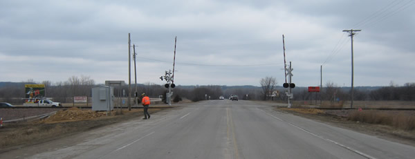 View from highway approaching railroad intersection