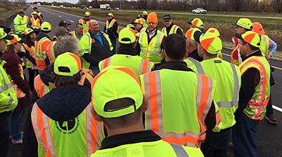 Photo of Dave Van Deusen speaking to other state DOT engineers at MnROAD.