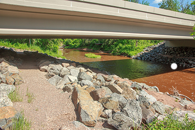 Close-up of a man-made wildlife path under a bridge.