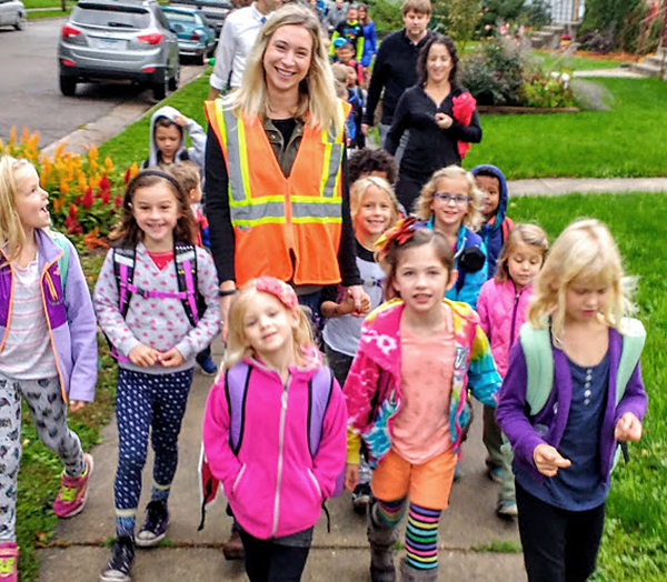 Photo of students and parents walking to school.