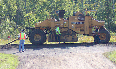 MnDOT road reclaimer grounds up asphalt.