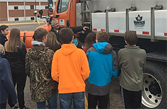 Photo of Mike Johnson with Detroit Lakes High School students.