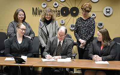 Charlie Zelle signs a pledge for Transportation Leaders Against Human Trafficking.