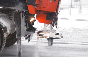 Snowplow distributing salt.