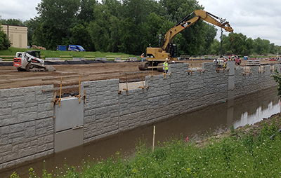 Crews operating machinery are on the Nine Mile Creek Causeway in June