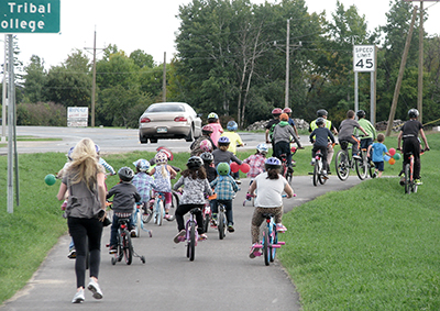 Photo of Children from the White Earth Nation riding bikes.