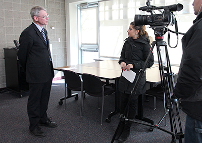 Photo of Duane Hill doing a television interview.