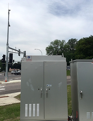 Photo of a transmitter cabinet and antenna.