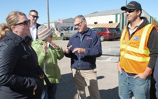 Photo of state leaders at Faribault airport.