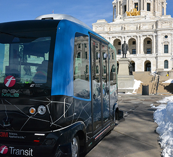 Photo of an automated shuttle bus outside the Capitol.