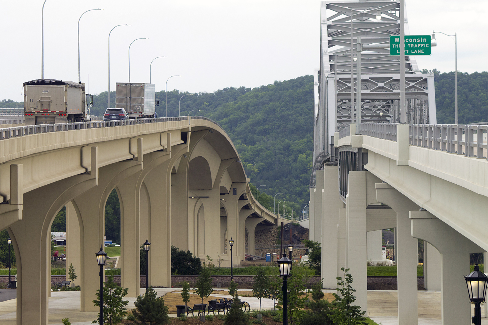 A photograph of two bridges crossing a river. The one on the right is older.