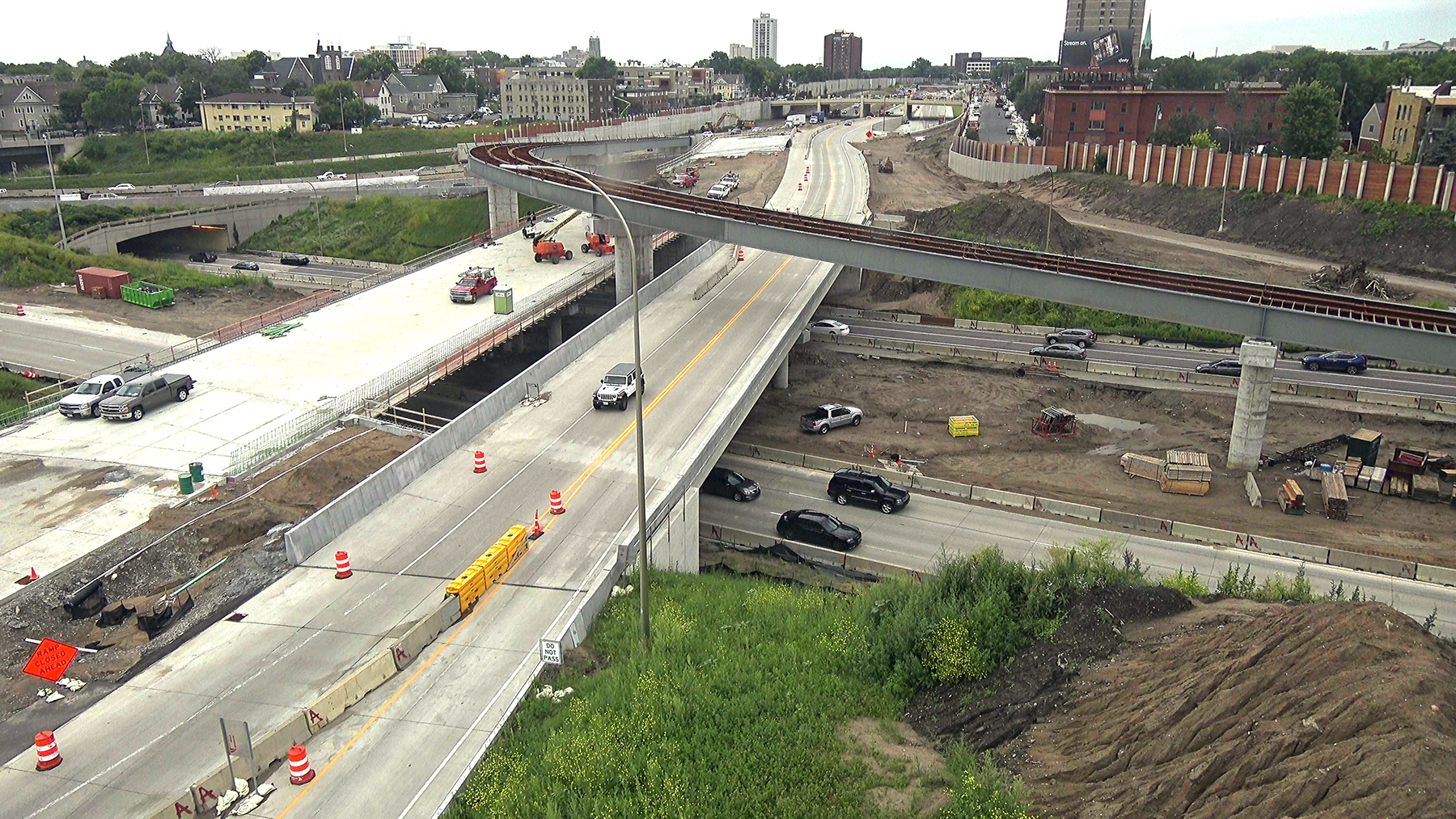 Minneapolis intersection of I-35 and I-94, in a state of semicompletion with construction equipment and piles of dirt.