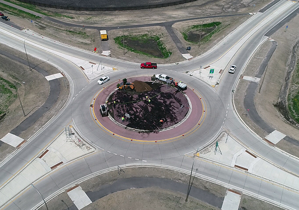 Overhead shot of roundabout, showing the plantings in the center and the four roads which meet at the location.