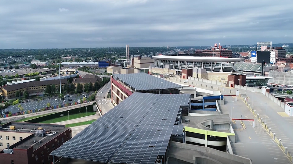 Solar panels on a rooftop in downtown Minnepolis. The Twins Stadium is in the background