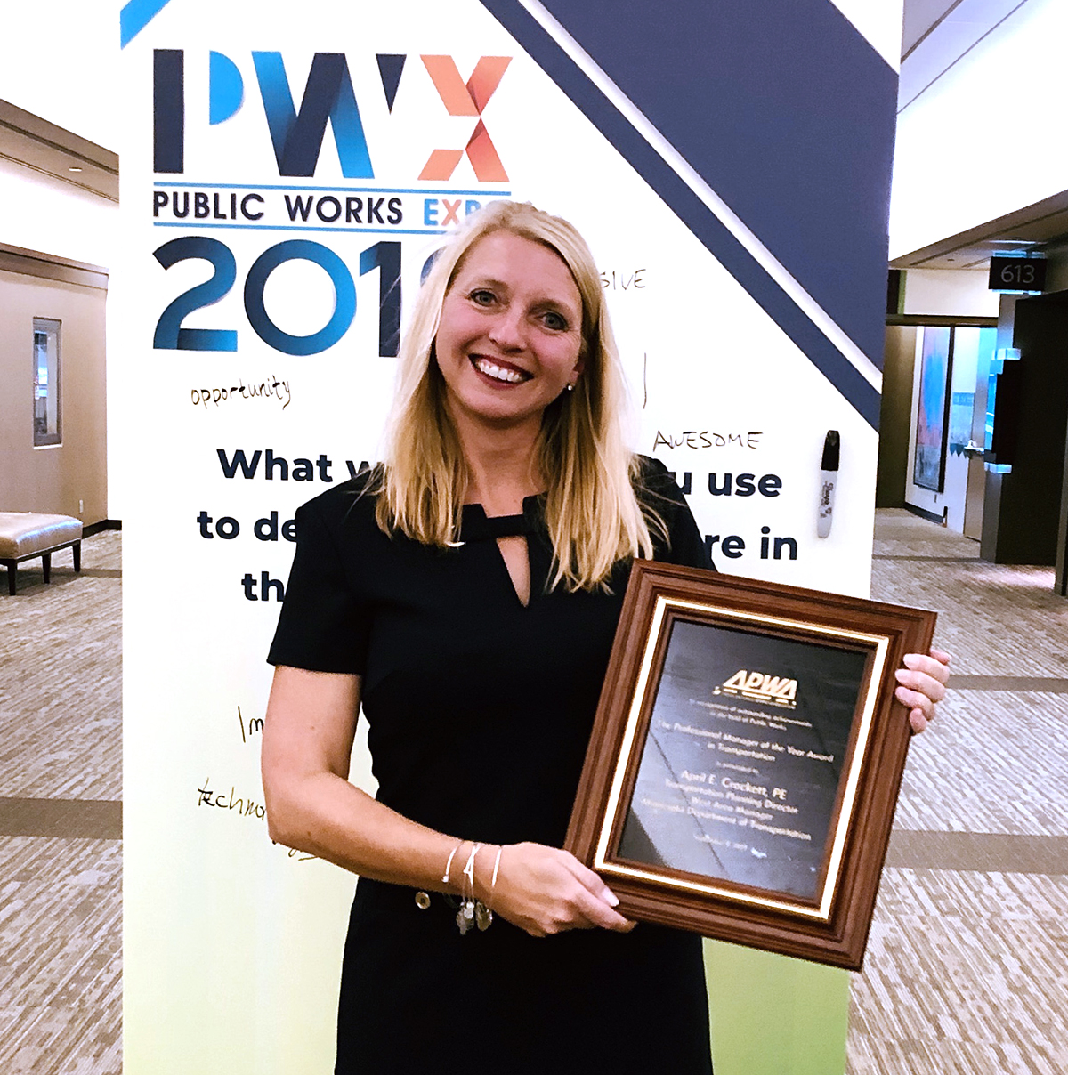 April Crockett holding her award plaque