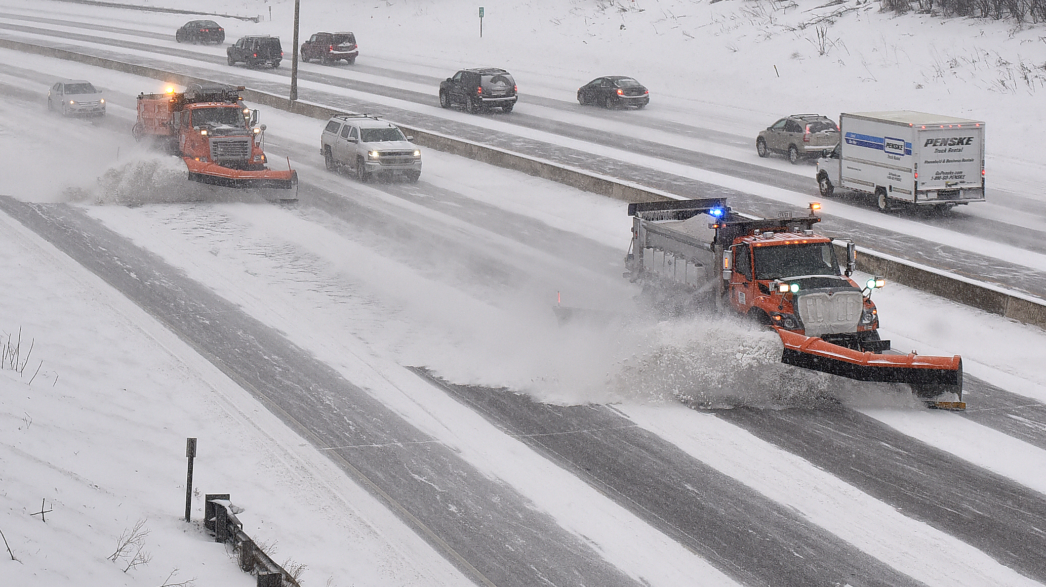 Photo: snowplows plowing snow on a highway