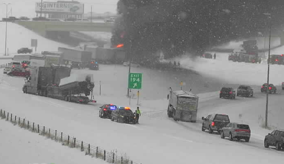 Photo: black smoke pours from a semi truck on fire, one of many involved in a multi-vehicle crash Nov. 12 near Monticello