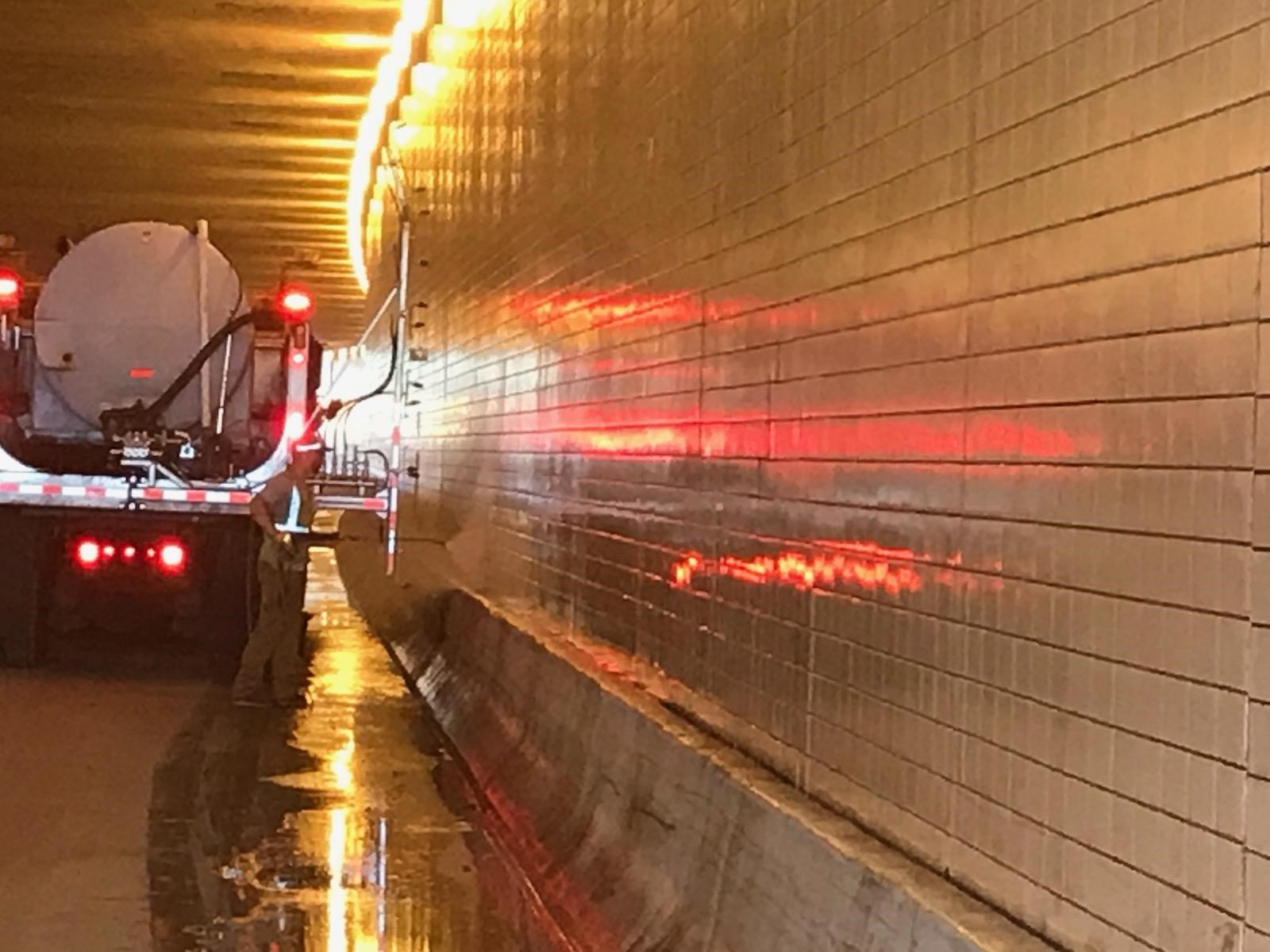 Photo: a truck in a tunnel spraying water at a tunnel wall