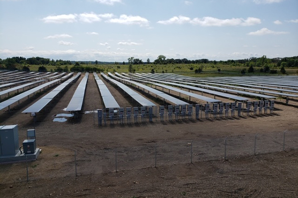 Photo: solar panels alongside a wooded area