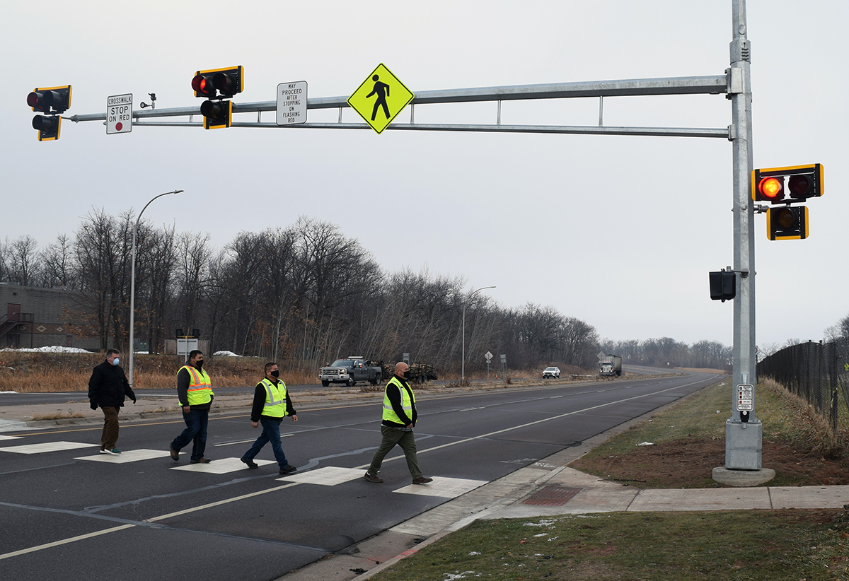 Photo: four people using a crosswalk