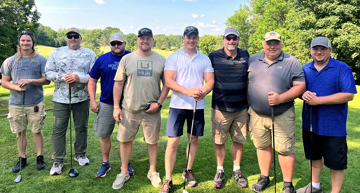 Photo of people lined up on a golf course