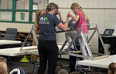 Photo: Cindy Morgan leads students in bridge building exercise.