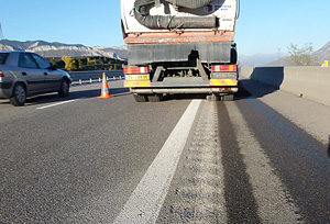 Photo of a rumble strip being ground into the pavement.