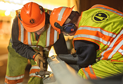 Photo MnDOT crew fixing guardrail.