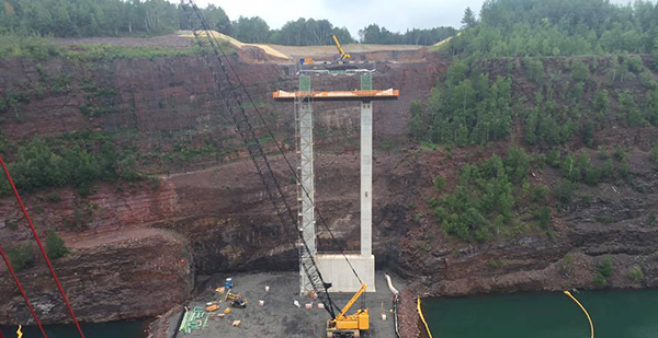 Hwy 53 bridge project shows construction of pier and sheer rock wall behind it
