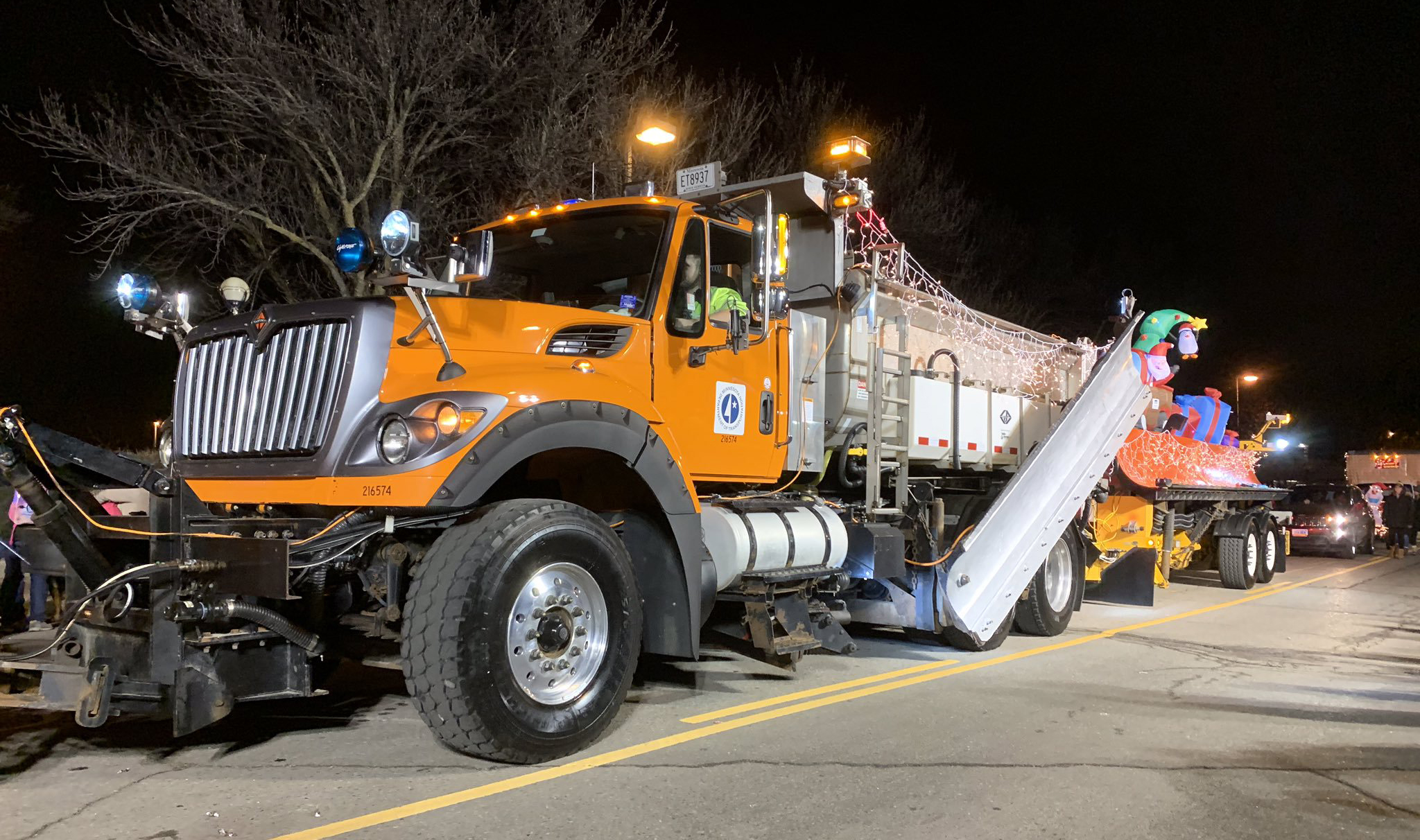Photo: a MnDOT snowplow covered in twinkling holiday lights