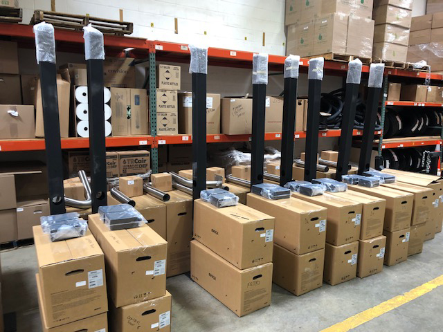 Brown cardboard boxes stacked upon one another in a warehouse setting