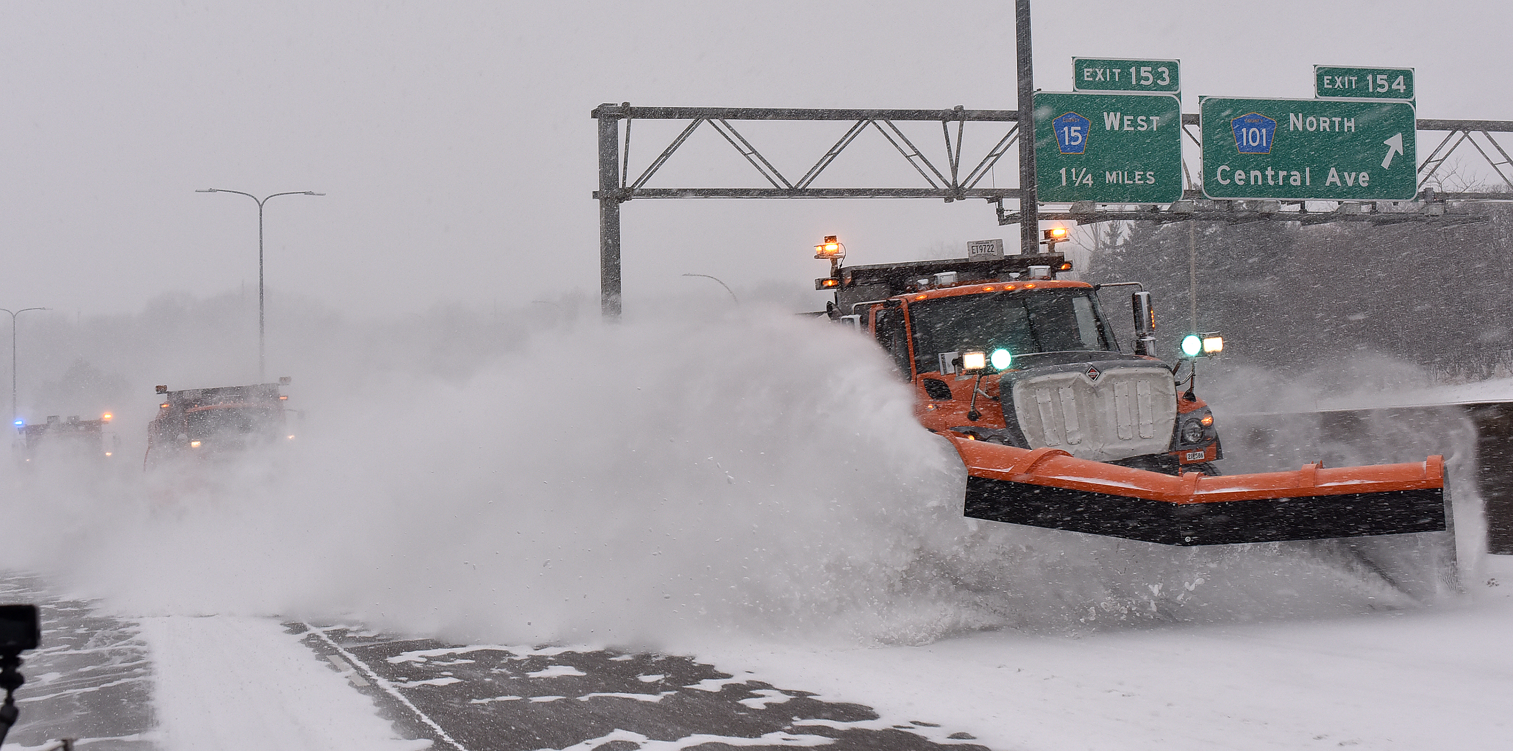 Photo: Three plows clear snow from a section of Interstate 394