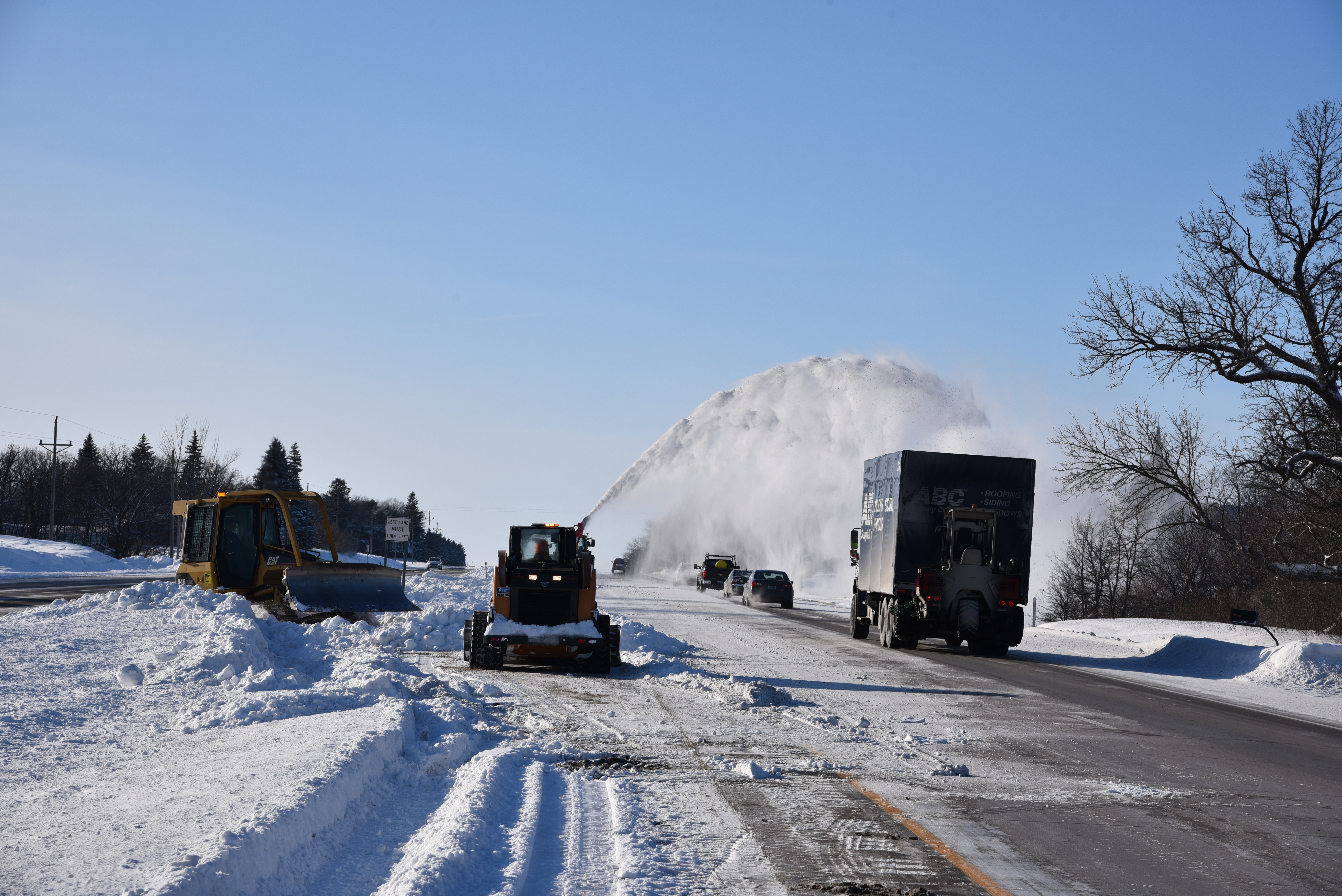 Photo: a snow blower unit clears snow from a highway median in District 4 in order to create more space for the snow that was forecasted to fall the next day.
