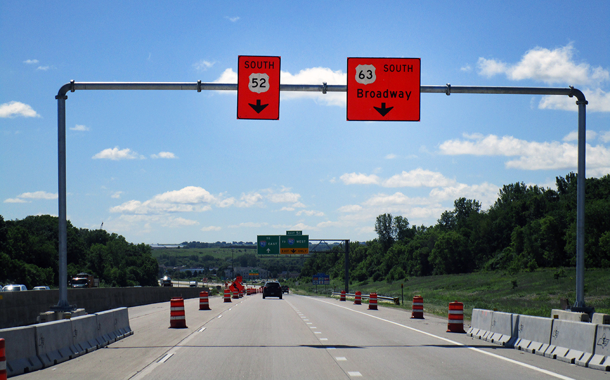 Photo: signs suspended over a roadway