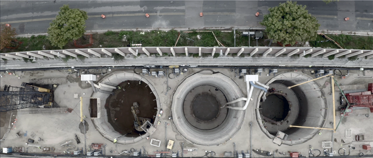 Photo: an overhead view of water wanks under construction next to I-35W