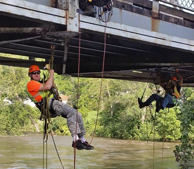 Photo: Scott Theisen, pictured underneath bridge L5391 in Cannon Falls, is in charge of MnDOT’s rope access inspection program. 